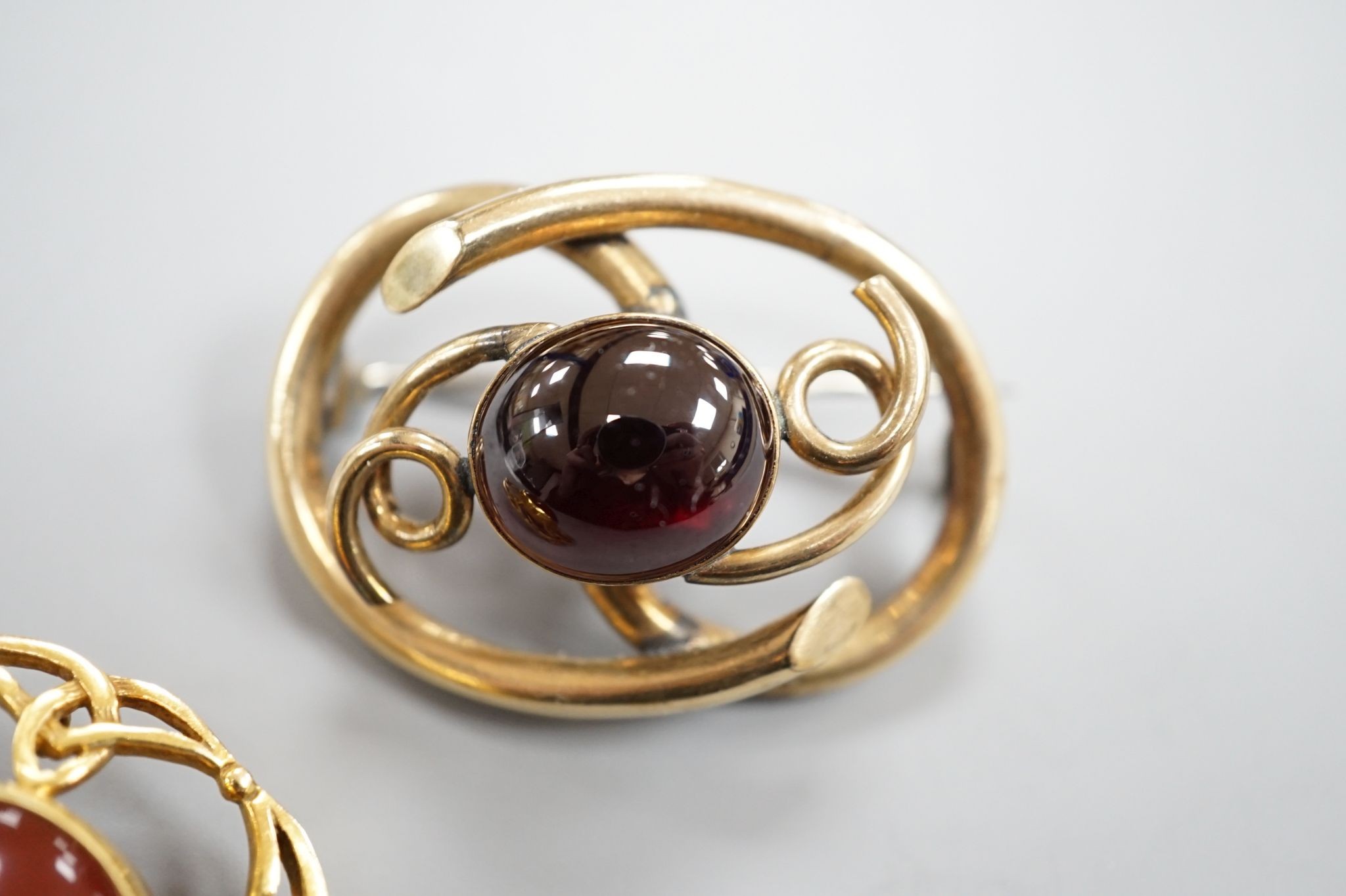 A late Victorian Scottish 9ct gold and carnelian set Iona brooch, 36mm, gross 10.1 grams and a Victorian mourning brooch.